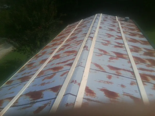 Rusted metal roof panels with new wood purlins before replacement — Storm Damage Roof Repair in Walden by Roofing Brothers