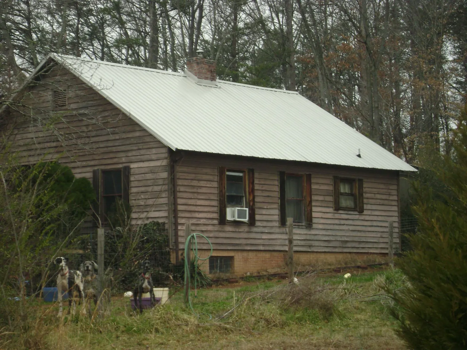 White metal roof on an old wood sided farmhouse, from a Metal Roof Installation job in Walden
